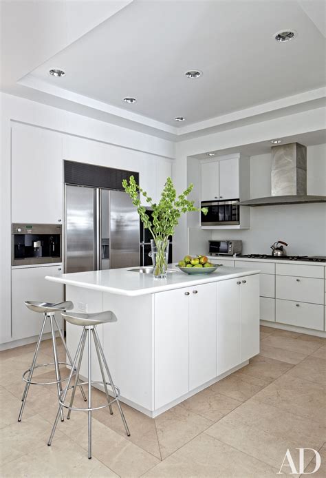 A refreshingly modern kitchen design with minimalist kitchen cabinets with mirror finish white laminates. White Kitchens Design Ideas Photos | Architectural Digest
