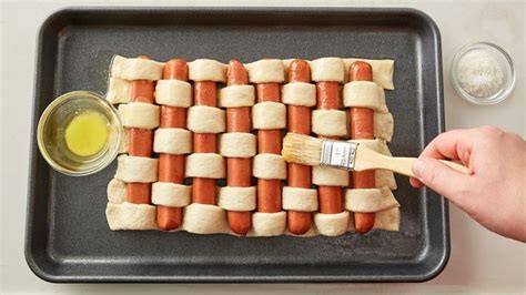 These sausage bites will be gone ina flash at your next party. Pretzel Woven Hot Dogs | Recipe | Hot dog recipes, Food, Memorial day foods