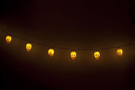 Image of Row of scull shaped lanterns glowing yellow ...
