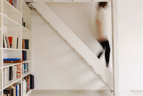 Woman Walking Downstairs In Living Room Del Colaborador De Stocksy Milles Studio Stocksy