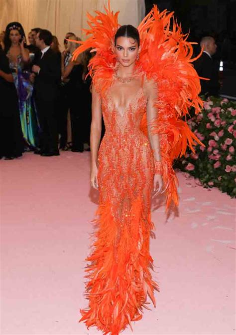 Kendall Jenner Shows Off Her Figure In Bright Orange Feathered Versace Gown At The 2019 Met Gala