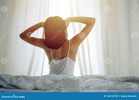 Woman Stretching Hands In Bed After Wake Up Sun Flare Brunette