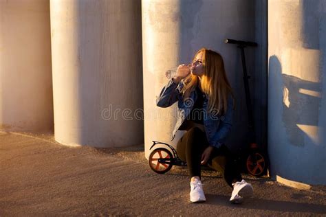 Beautiful Blonde Woman Sitting On A Scooter Drinking Water Stock Image Image Of Bike Outdoors