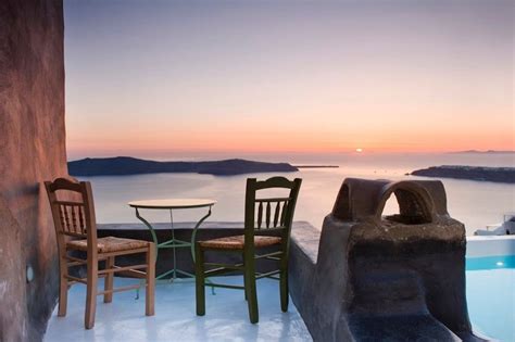 Two Chairs And A Table Sitting Next To An Outdoor Hot Tub With A View Of The Ocean