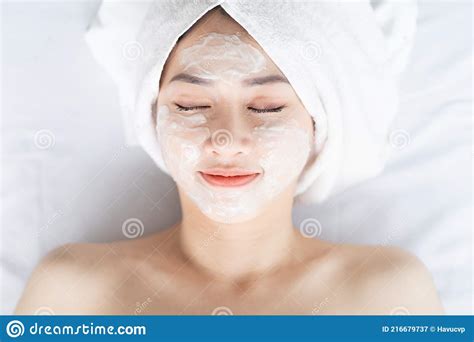 Asian Woman Doing Beauty Treatments Spa Treatments And Being Applied Cream To Her Face Stock