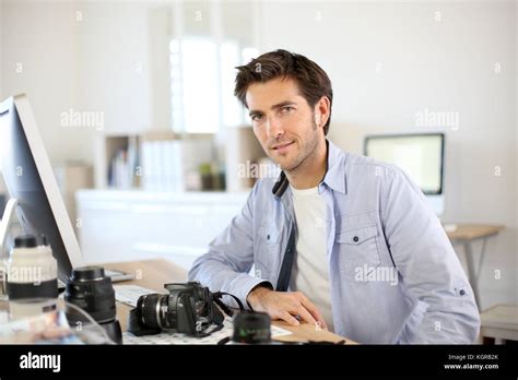 Photographer In Office Working On Desktop Computer Stock Photo Alamy