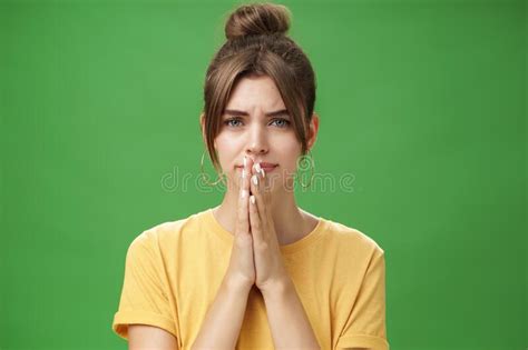 Waist Up Shot Of Nervous Upset Girlfriend Holding Hands In Pray Over