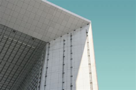 Low Angle Shot Of A White Modern Building Under The Blue Sky Free Photo