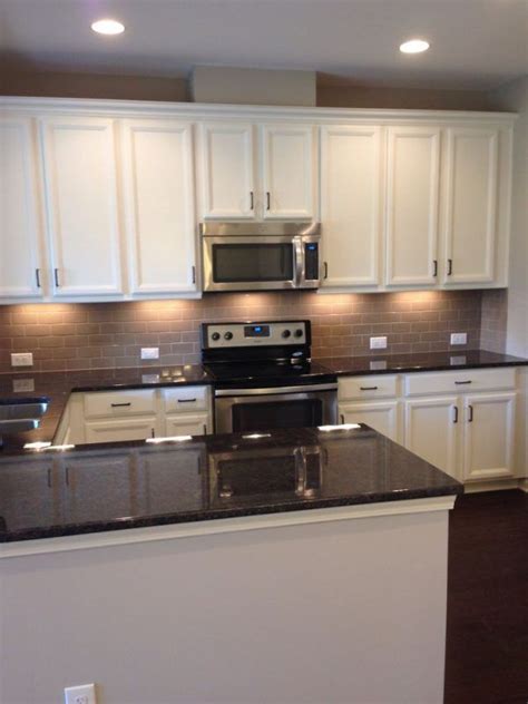 This luxurious kitchen is also featuring brushed stainless steel. under-cabinet-lights-kitchen-with-glass-top-electric-range ...