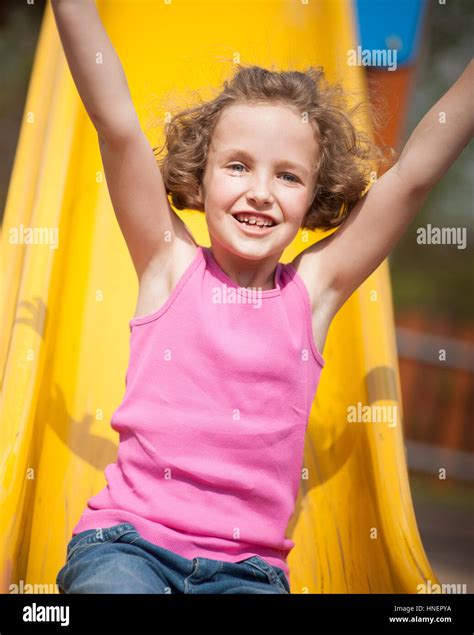 Close Up View Of Young Girl On Slide In Playground Stock Photo Alamy