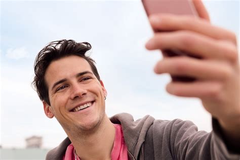 Premium Photo Happy Young Man Taking A Selfie Portrait With His Smart