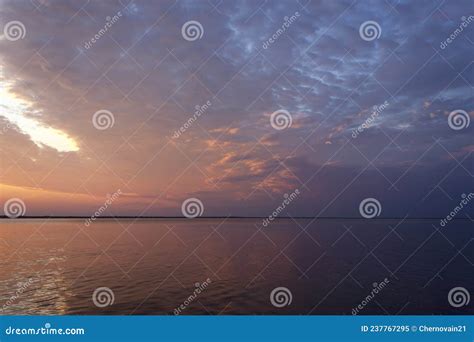 Sun Rises From The Horizon And Beautifully Illuminates The Clouds Stock
