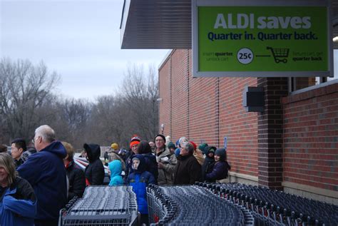 Customers Line Up Outside The Brand New Aldi Supermarket At Its Grand