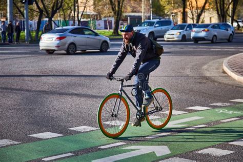 Guy Is Cycling Around The City Intersection On A Cycle Path Eco