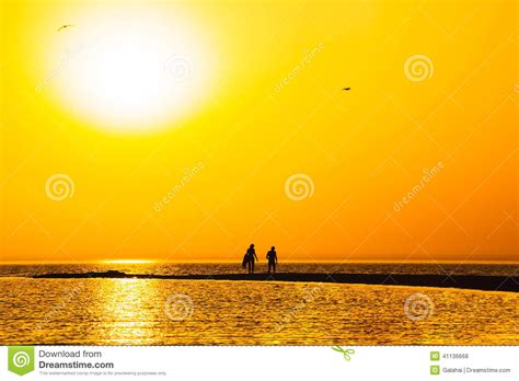 Orange Sunset Over The Sand Spit In The Sea Stock Photo