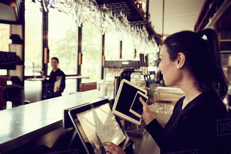 Side View Of Coworker Talking To Owner In Cafe Stock Photo Dissolve