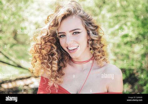 perfect curly hair blonde curly long hair perfect woman smiling on spring sunny background