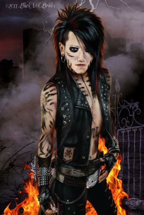 A Man With Tattoos And Piercings Standing In Front Of Fire