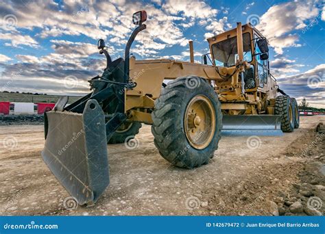 Excavator Machine Leveling The Ground With A Large Shovel Stock Photo