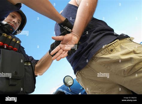 Police Man Putting Handcuffs On Criminal Stock Photo Alamy