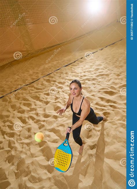 Woman Hitting Tennis Ball With Racket On Sand With Left Hand Stock Photo Image Of Female