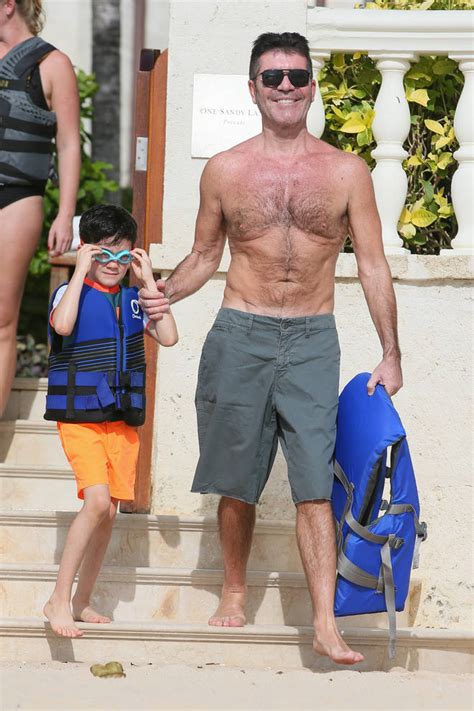 simon cowell reveals toned physique on the beach in barbados following two stone heart