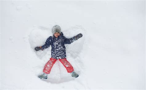 Boy Making Snow Angel Stock Photo Download Image Now Snow Angel
