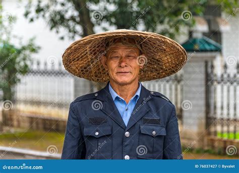 Portrait Of Chinese Man In Traditional Straw Wide Brimmed Hat Editorial
