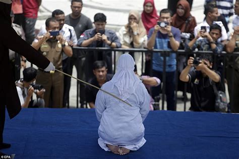 Indonesian Woman Collapses In Pain As She Is Flogged For Showing Affection In Public Daily
