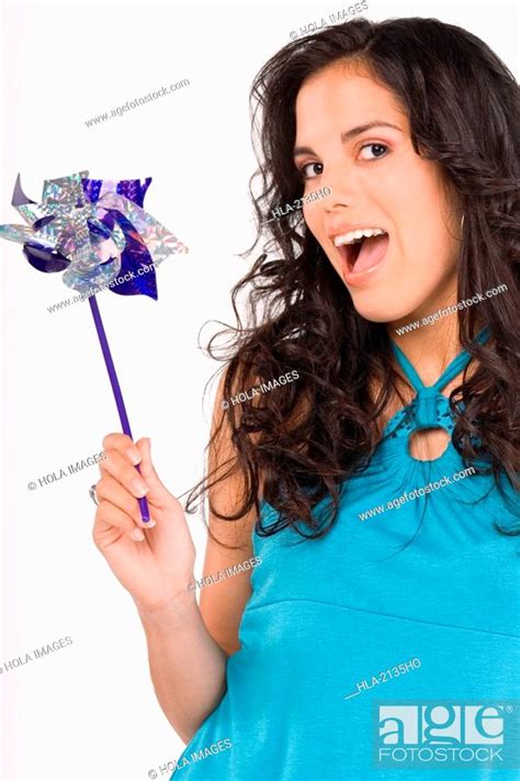 Portrait Of A Teenage Girl Holding A Pinwheel And Looking Surprised