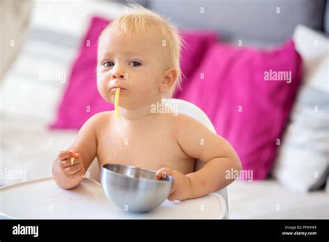 Adorable Little Baby One Year Old Eating Pasta Indoor Funny Toddler