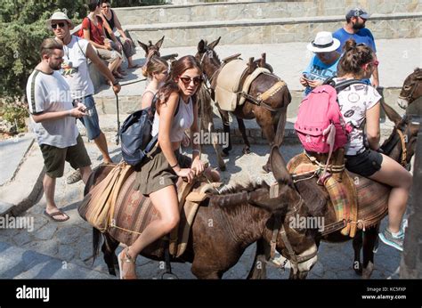 Tourists Riding Donkeys Lindos Rhodes Greek Islands Greece Stock Photo