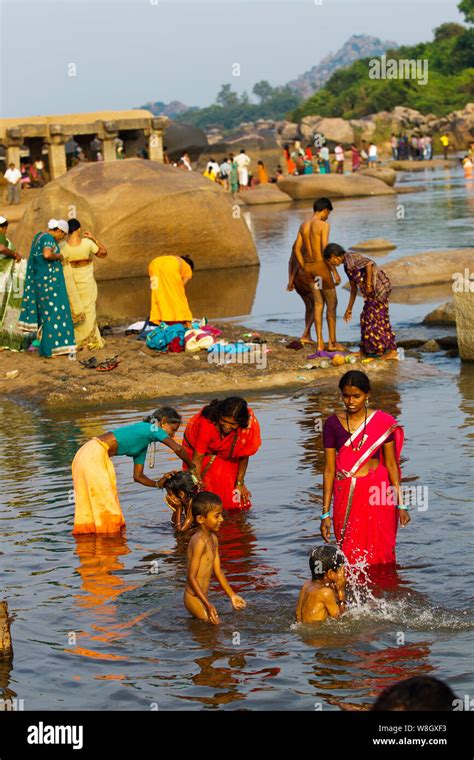 Mother Bathing His Son At Tungabhadra River Hampi Karnataka India
