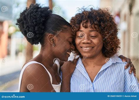 african american women mother and daughter hugging each other at street stock image image of
