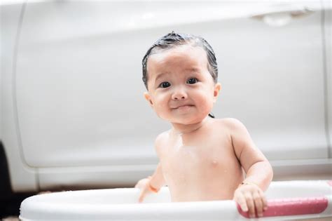 Premium Photo Adorable Baby Girl Taking Bath In White And Pink Tub