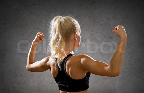 Sporty Woman From The Back Flexing Her Biceps Stock Image Colourbox