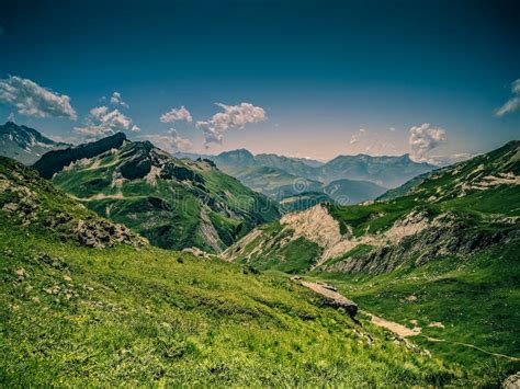 Mountain Grassy Ranges With Rocky Hills And Snow Trekking In Summer