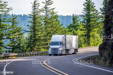 White Big Rig Semi Truck Transporting Goods In Refrigerated Semi