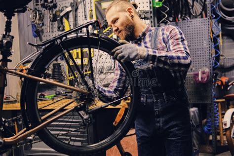Mechanic Doing Bicycle Wheel Service Manual In A Workshop Stock Photo