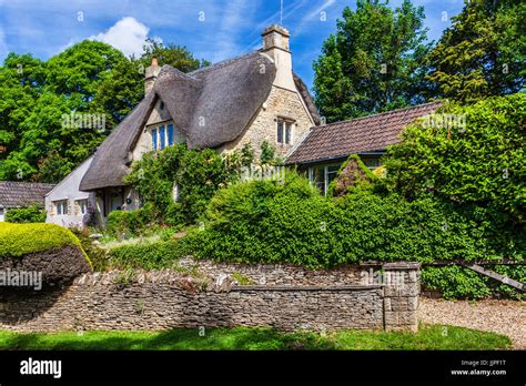 A Picturesque Thatched Cottage In The Cotswold Village Of Castle Combe