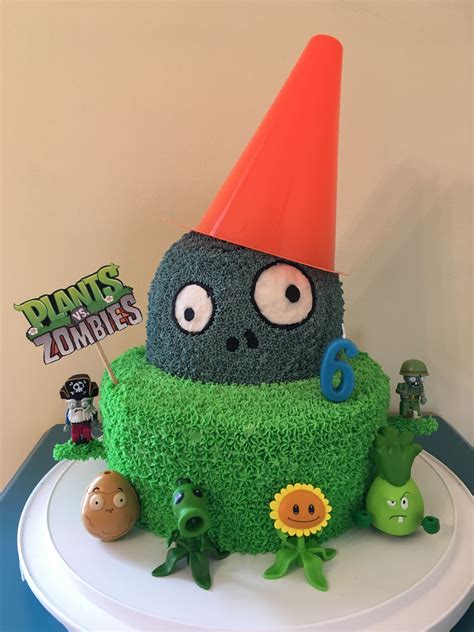 A Birthday Cake With Plants And Monsters In The Middle Including An