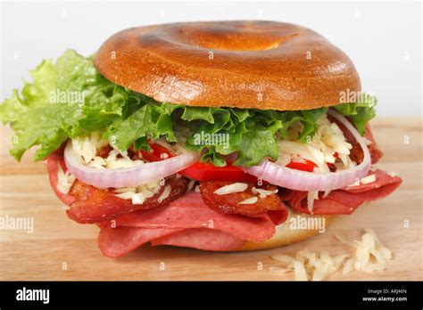 Cross Section Of Bagel Sandwich With Ham Fried Bacon Cheese Lettuce