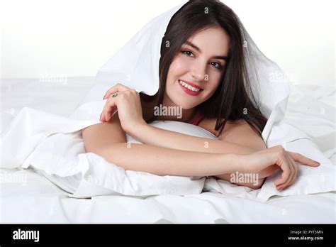 Portrait Of A Peaceful Beautiful Woman In Bed Resting And Happy