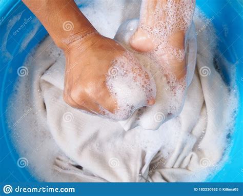 Wash White Clothes And Soak Cloth In Laundry Detergent Water In Tub