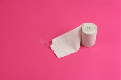 Roll Of Rough White Toilet Paper On Pink Background Close Up Copy