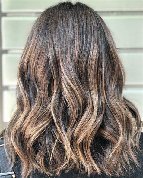 Curly short brown hair with bright caramel highlights. 34 Best Caramel Highlights for Every Hair Color