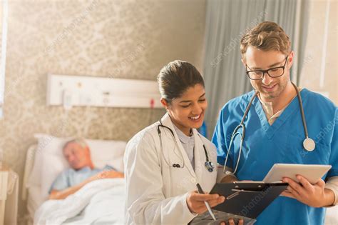 Female Doctor And Male Nurse Making Rounds Stock Image F