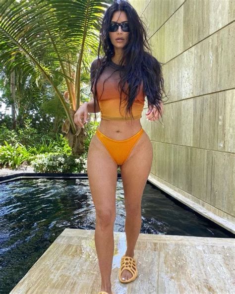 kim kardashian wearing tie dye t shirt and orange bikini what stars own