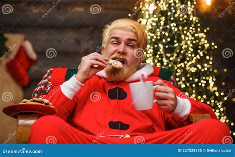 Santa Claus Eat Cookies And Drinking Milk Bearded Man In Santa Costume