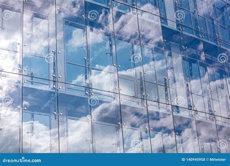 Glass Wall Of Modern Office Building With Cloudy Sky Reflection Stock